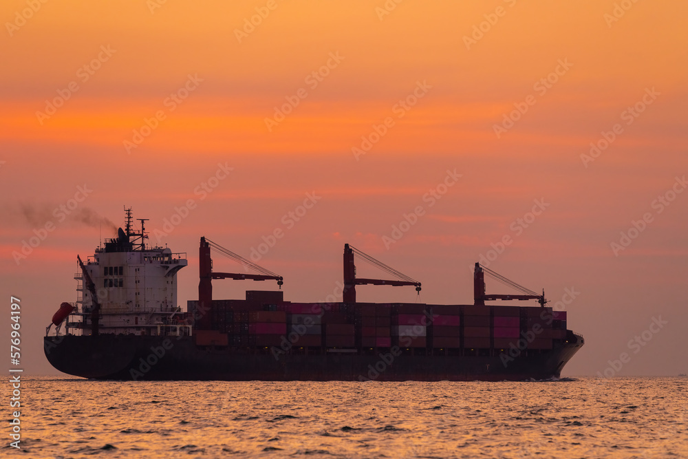 Silhouette cargo shipping transportation logistic commerce industry loading export on open sea with twilight sky background
