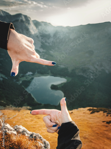 Framing mountain lake with a fingers photo