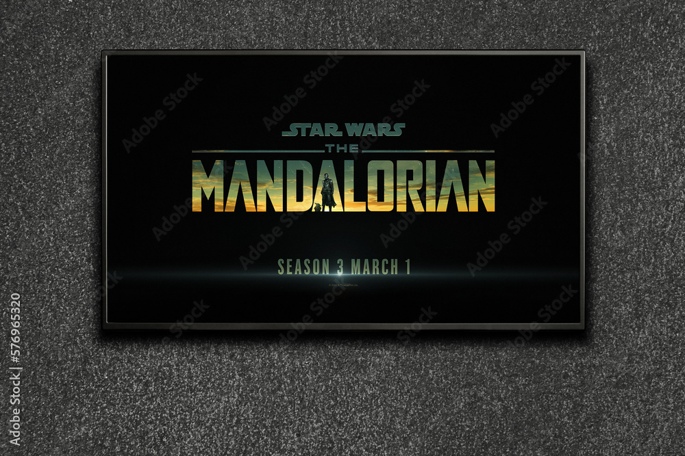 Naklejka premium TV screen playing Mandalorian trailer or movie. TV on black textured wall. Moscow, Russia - January 18, 2023.