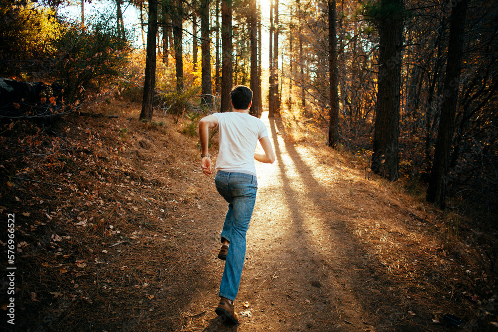 A man running through the forest A man running through the forest