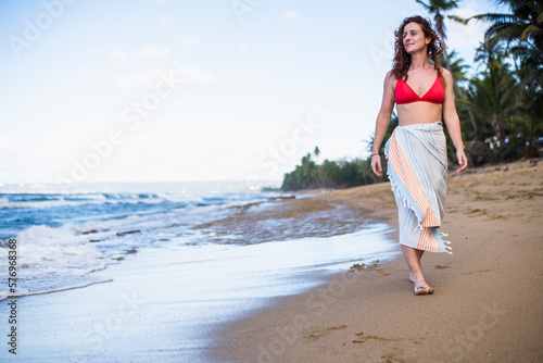 Solo Woman in a bikini with towel at the beach in Puerto Rico photo