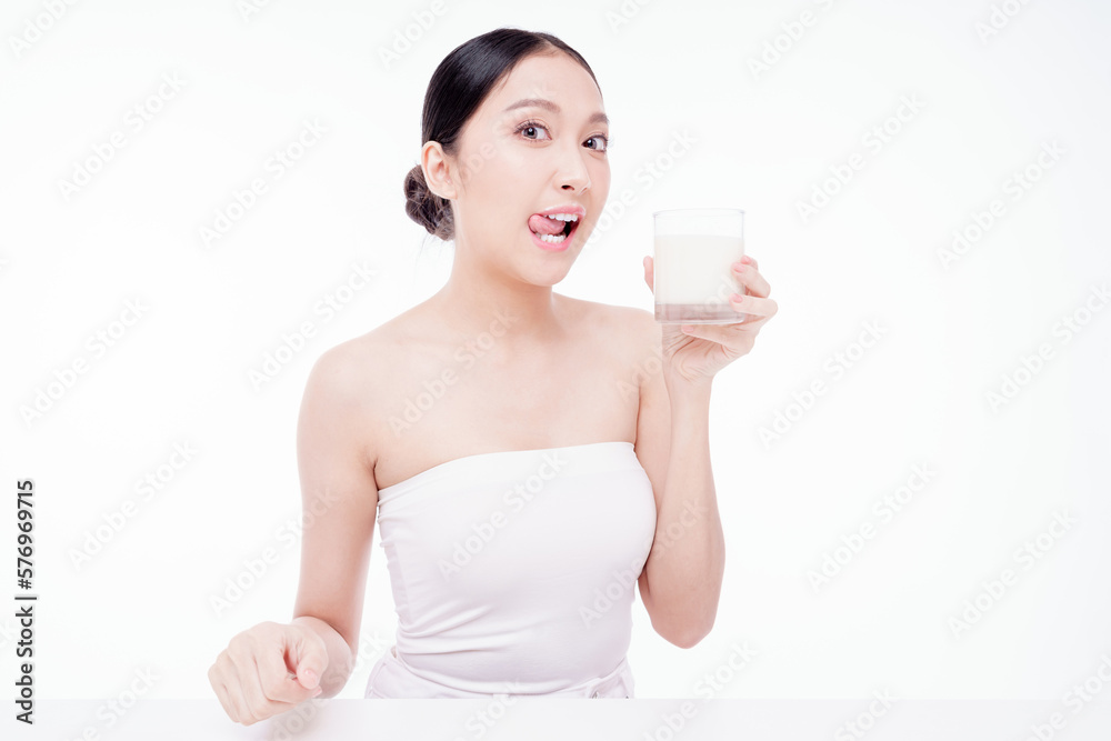 Young happy woman 20s wear white t-shirt hold glass of milk isolated on white background studio. Her mouth was stained with milk after she drank. Healthy drink lifestyle concept. Young happy woman 20s wear white t-shirt hold glass of milk isolated on white background studio. Her mouth was stained with milk after she drank. Healthy drink lifestyle concept.