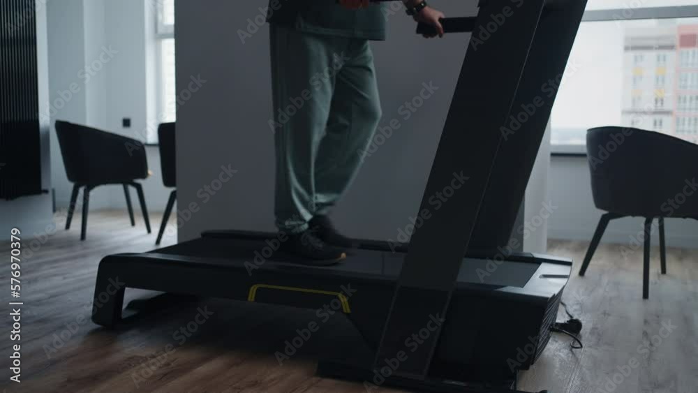 Legs Of Sick Aged Man Walking On Treadmill At Home, Rehabilitation After Joint Disease And Operation