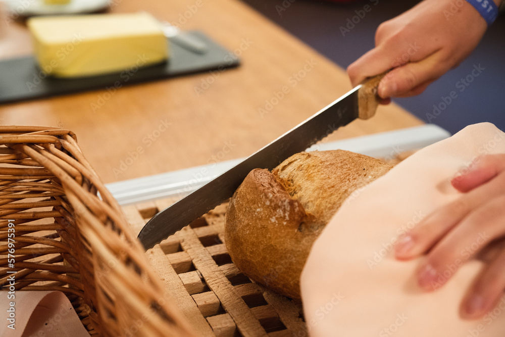 Cutting fresh bread at the buffet Cutting fresh bread at the buffet
