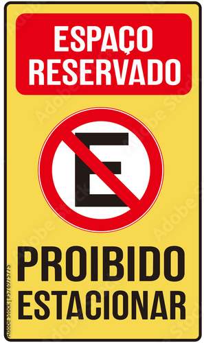 A sign in yellow color that says in Portuguese language : no parking reserved space