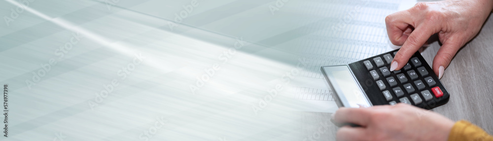 Female hands making calculation; panoramic banner Female hands making calculation; panoramic banner