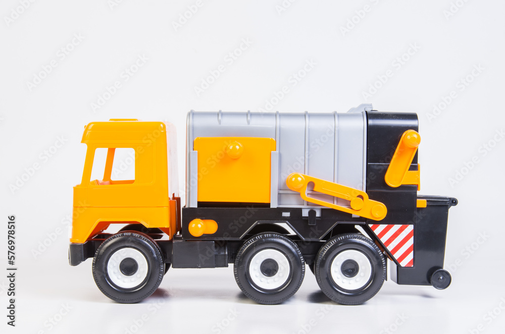 Garbage truck. Multi-colored children's toys plastic trucks on a white background.