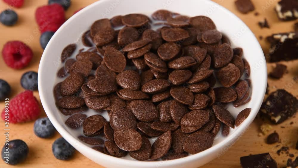 Stirring a bowl of chocolate cereal.