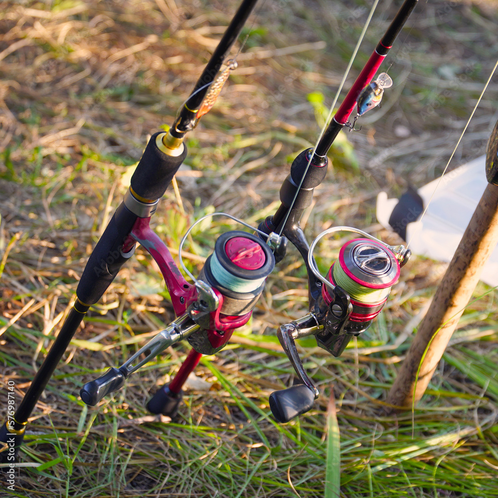 Spinning rods with reels and lures ready for fishing Spinning rods with reels and lures ready for fishing