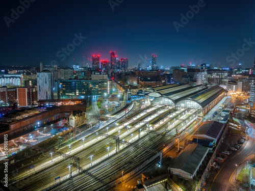 Fototapeta Naklejka Na Ścianę i Meble -  Picadilly train station Manchester City Centre and construction and redevelopment work at dawn with city lights and dark skies of this English city.	