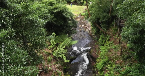 Bridge With River Flowing On Rocks With Lush Trees At Parque das Frechas In Agualva, Terceira, Azores, Portugal. Reveal photo