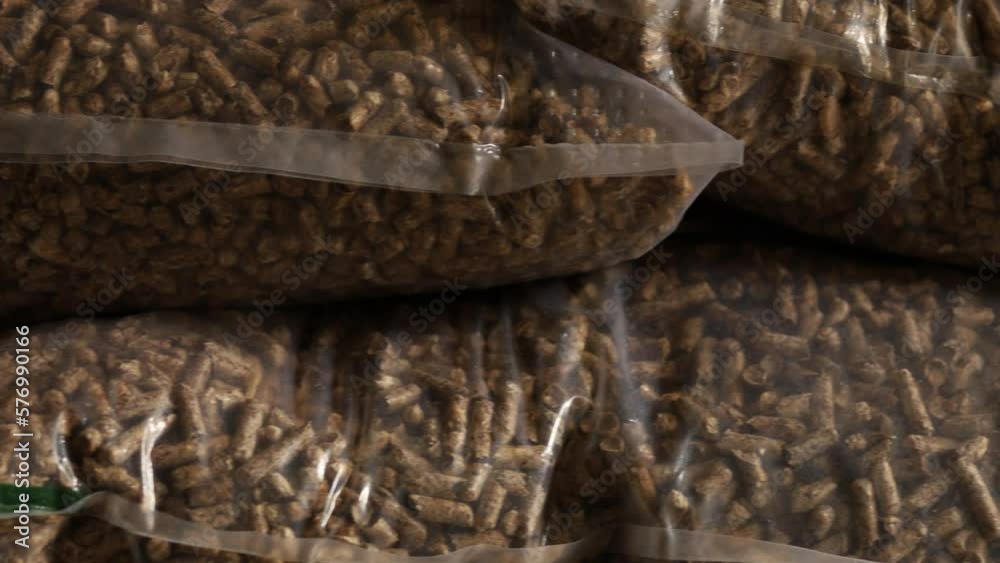Vidéo Stock Slider shot of bags of wood pellets stacked on each other, for use as an eco