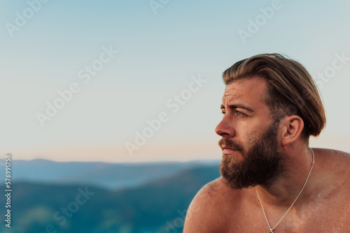 An athlete rests on top of a mountain after exhausting running training.