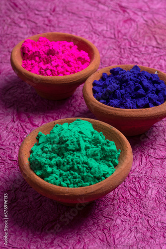 Top view of colorful traditional holi powder in bowls isolated on white background. Space for text. Concept Indian color festival called Holi.