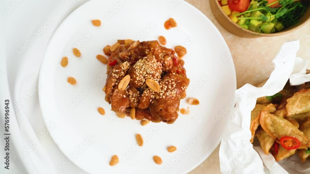 Chicken with spicy sweet and sour sauce and rice. A healthy breakfast in disposable paper dishes that you can order to take away from a restaurant Chicken with spicy sweet and sour sauce and rice. A healthy breakfast in disposable paper dishes that you can order to take away from a restaurant