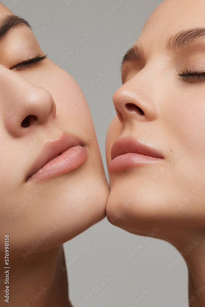 Cropped portrait of young beautiful female couple. Models with well-kept skin and nude makeup. Concept of emotions, beauty, vision, health and fashion