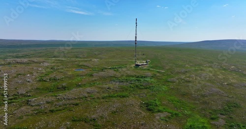 Aerial view approaching a radio tower on top of the Ailikastunturi fell, sunny summer day in Utsjoki, Finland photo