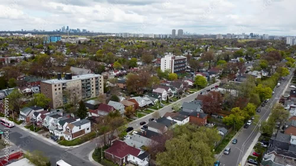 Drone flying through a grey, overcast and foggy Toronto neighborhood in early spring.