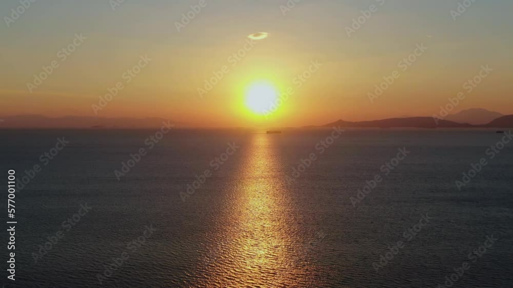 Golden sunset over the sea in Greece with ship in the background Golden sunset over the sea in Greece with ship in the background