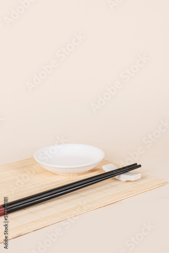 sushi set with bamboo placemat on beige background photo