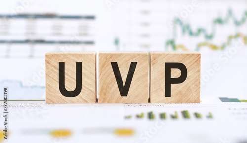 Unique Value Proposition concept presented on wooden cubes on financial background