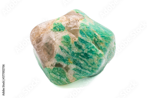 A tumbled chunk of light green and blue amazonite crystal with a clear quartz matrix focused and isolated on a white surface background photo