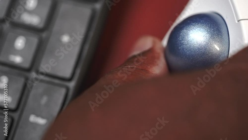track ball keyboard typing black man working computer at desk