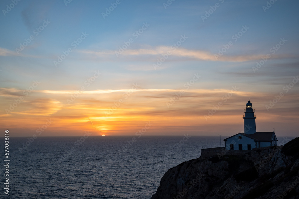 Sunrise from sea with lighthouse