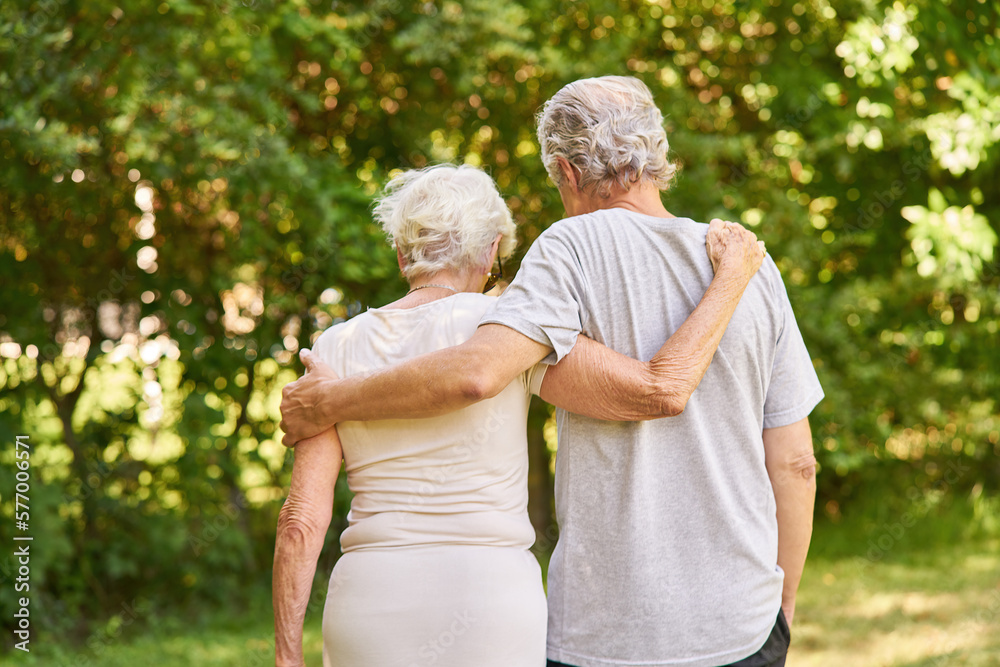 Couple of seniors walking arm in arm in nature Stock Photo | Adobe Stock