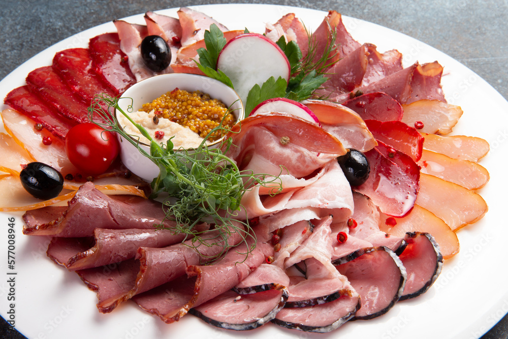 Sliced meat delicacies in a plate.