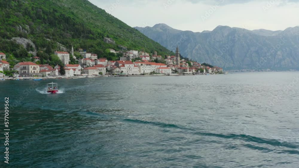 Perast, Montenegro, may 2022: tourist boats goes to the island near coast of perast city, establishing view montenegrin attraction. Close up shot