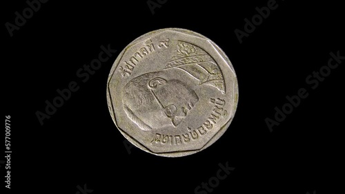 Obverse of Thailand coin 5 baht 1992 with portrait of king Bhumibol Adulyadej and inscription meaning 5 BAHT THAILAND. 4k video photo