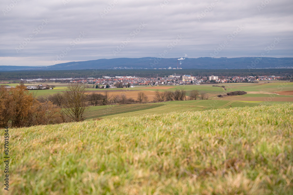 Cityscape of Schaafheim, with agricultural fields in the front and Mountain range in the background during cloudy day, Germany Cityscape of Schaafheim, with agricultural fields in the front and Mountain range in the background during cloudy day, Germany