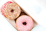 Assorted donuts in the box on white background