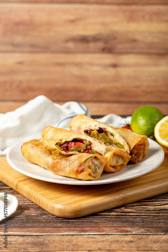 Pacanga pastry. Turkish cuisine delicacies. Pastry made with phyllo, tomato, green pepper, capia pepper, cheddar cheese and pastrami. Ramadan food. Local name paçanga boregi Pacanga pastry. Turkish cuisine delicacies. Pastry made with phyllo, tomato, green pepper, capia pepper, cheddar cheese and pastrami. Ramadan food. Local name paçanga boregi