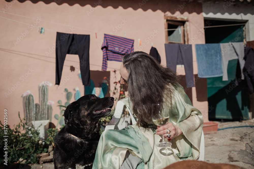 Mature woman on her terrace with her dog