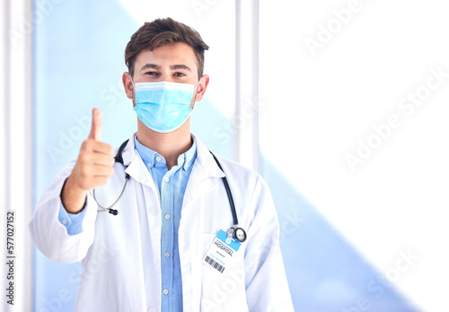 Portrait, doctor and man with thumbs up, mask and success for cure, diagnosis and safety compliance. Face cover, male and medical professional with gesture for ok, emoji and healthcare with mockup