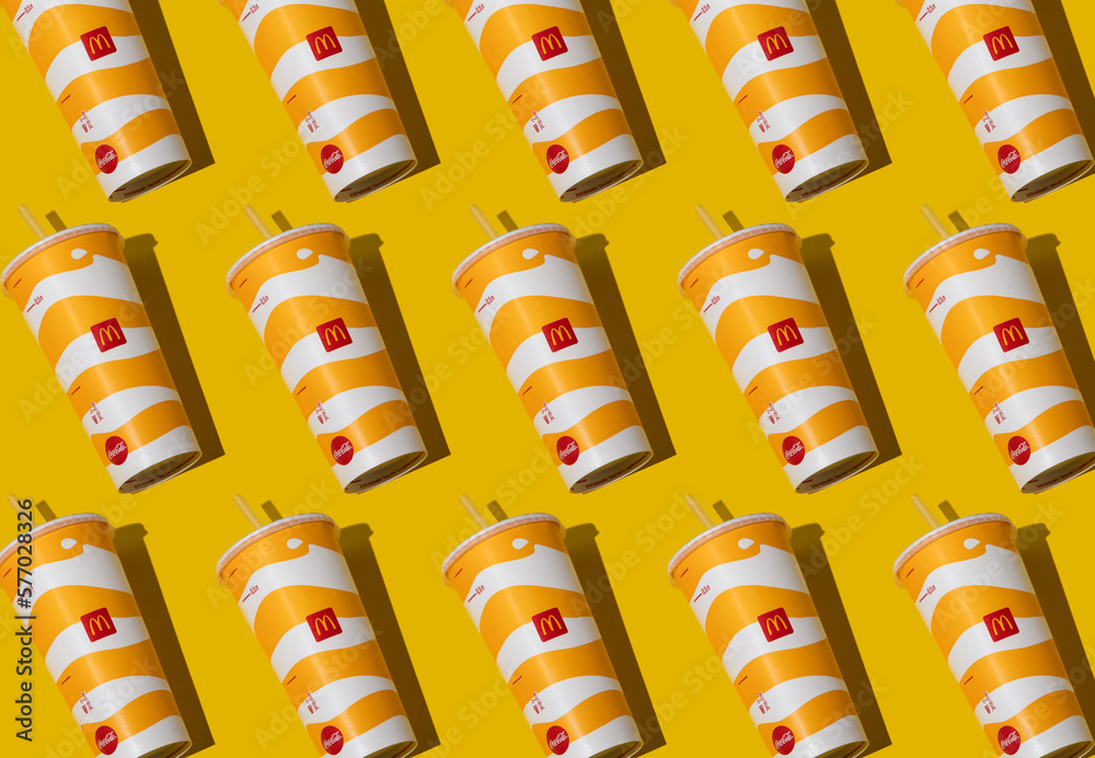 Yellow glass of McDonald's pattern. Paper cup with lid. Takeaway drink ...