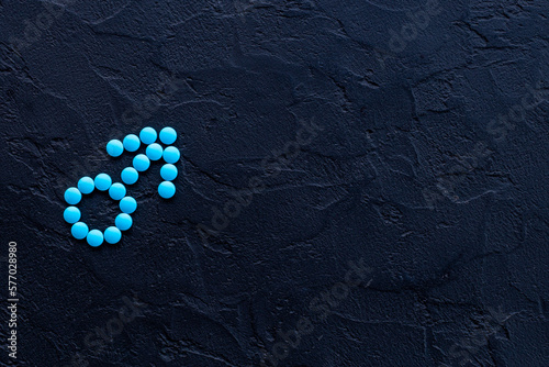 Male sign made of blue pills. Impotence concept. Mans health concept photo