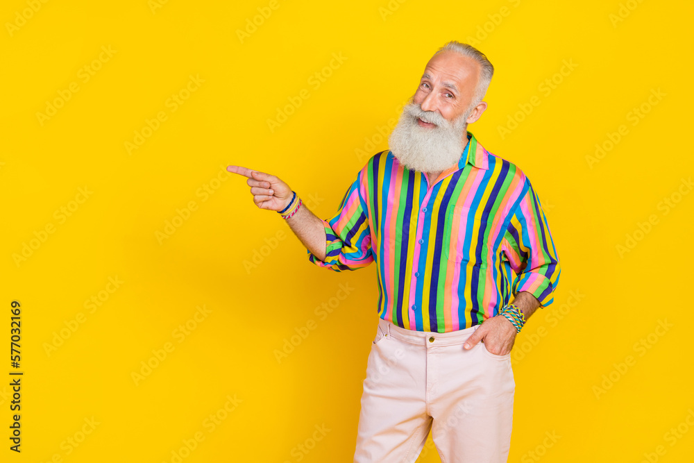 Photo of positive nice person indicate finger empty space proposition isolated on yellow color background