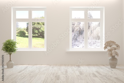 White empty interior concept in hight resolution with summer and winter landscape in window. 3D illustration © AntonSh