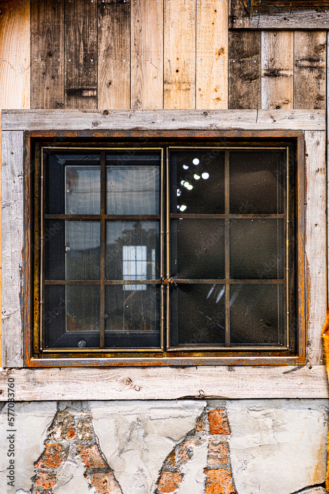 Old window with the rusty frame, Jeju island, South Korea
