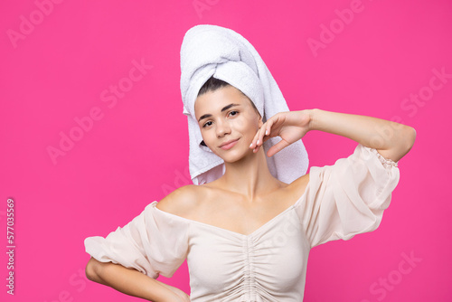 Wallpaper Mural Portrait of young beautiful woman after bath. Beauty face of a cheerful attractive girl with towel on head against a pink background. Torontodigital.ca