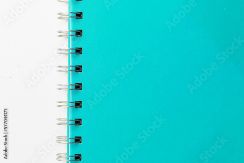 Close-up of a blue notebook with checkered pages. Spiral notebook isolated