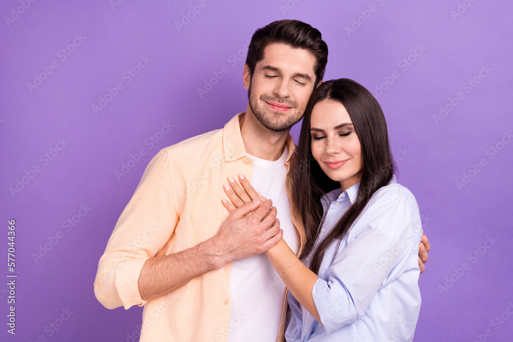 Photo of relaxed harmony trust positive young students hands together love story romance closed eyes feelings isolated on violet color background Photo of relaxed harmony trust positive young students hands together love story romance closed eyes feelings isolated on violet color background