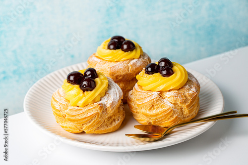 Fotobehang Italian pastry - zeppole di San Giuseppe, zeppola - baked puffs made from choux pastry, filled and decorated with custard cream and cherry