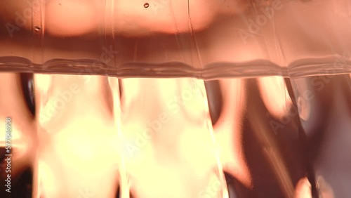 macro level view of water in bottle bright light