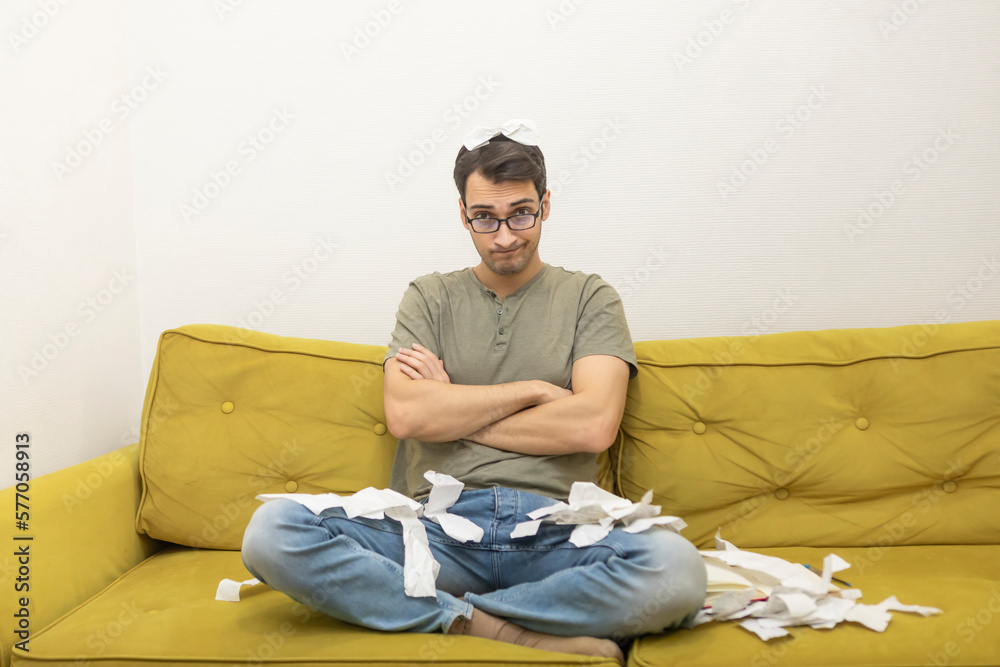 Fototapeta premium Close up of unhappy man sitting on the couch, stressed and confused by calculate expense from invoice or bills, have no money to pay mortgage or loan. High prices and spending money concept