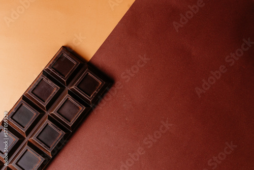 a whole bar of dark chocolate on a two-tone background
