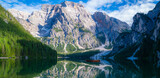 Braies Lake in Dolomites mountains forest on the background. The lake is surrounded by forest which are famous for scenic hiking trails. Mountain landscape, lake and mountain range.